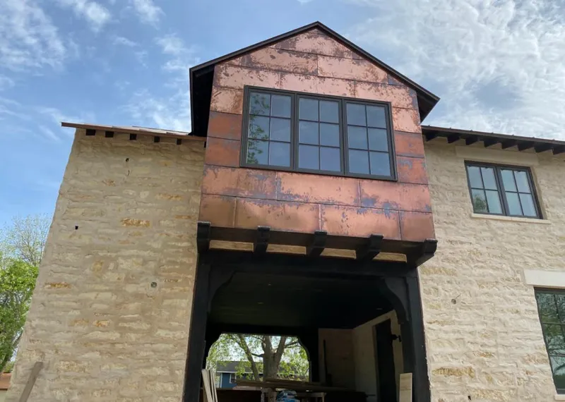 Copper metal panel facade on a stone building for Roof Repair in Aptos